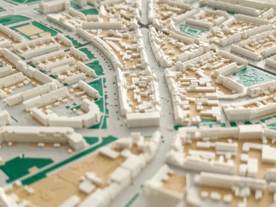Detail van een 3D-geprinte maquette met meerdere woonwijken: rijtjeshuizen, bouwblokken en stervormig samenkomende straten